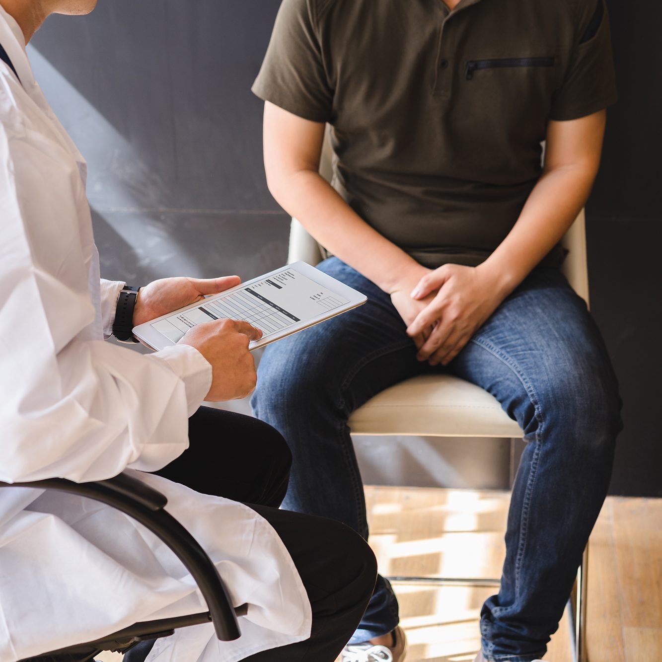 Male doctor and testicular cancer patient are discussing about testicular cancer test report. Testicular cancer and prostate cancer concept.